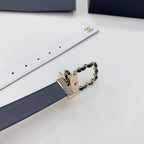Leather belt laid flat with dark blue strap, gold-tone buckle, and chain link detail