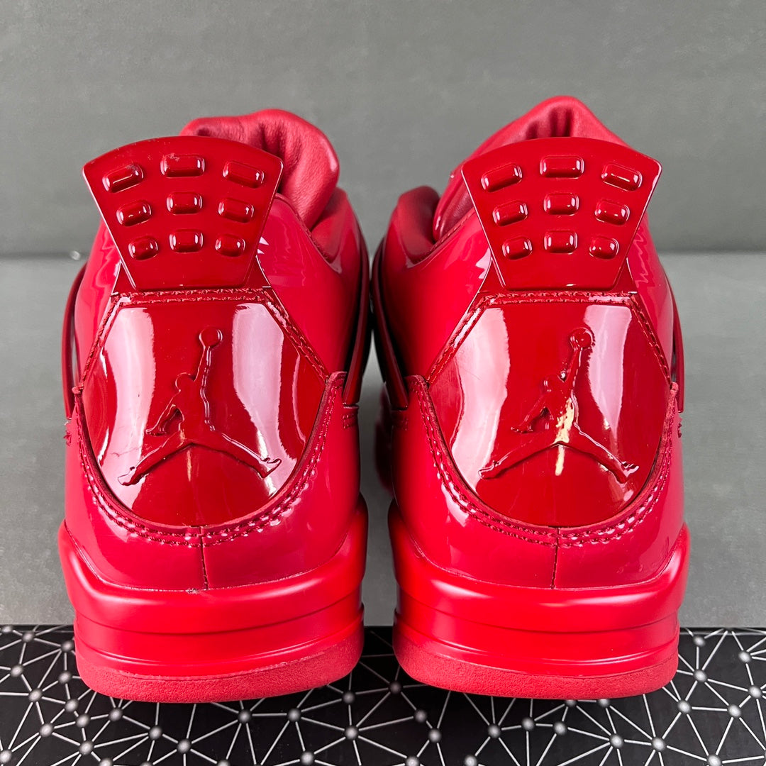 Pair of red patent Jordan sneakers heel view with Jumpman emblem