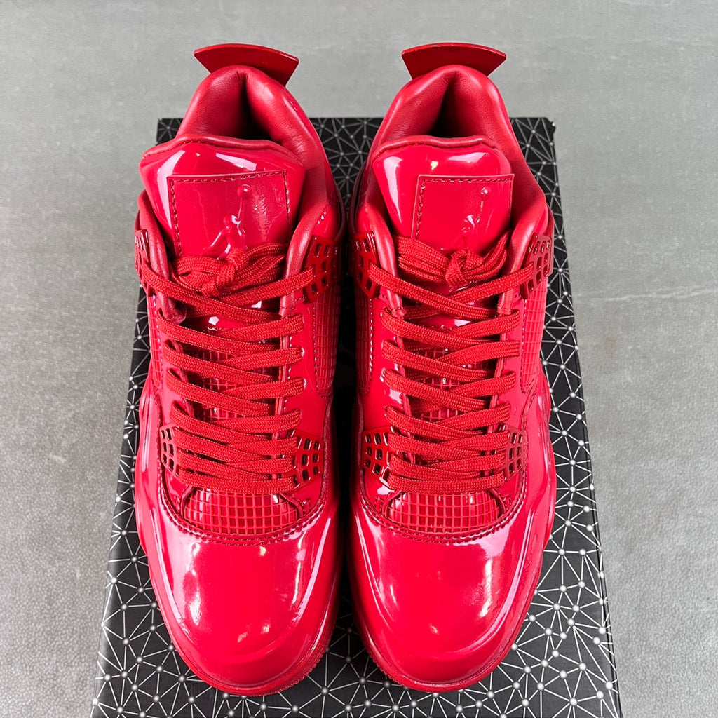 Pair of red patent Jordan sneakers viewed from back with lace-up ankle tabs