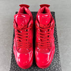 Pair of red patent Jordan sneakers viewed from back with lace-up ankle tabs