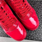 Red patent Jordan sneakers close-up of toe box and lace-up ties