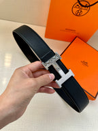Dark leather belt with silver-tone H buckle, single-prong closure
