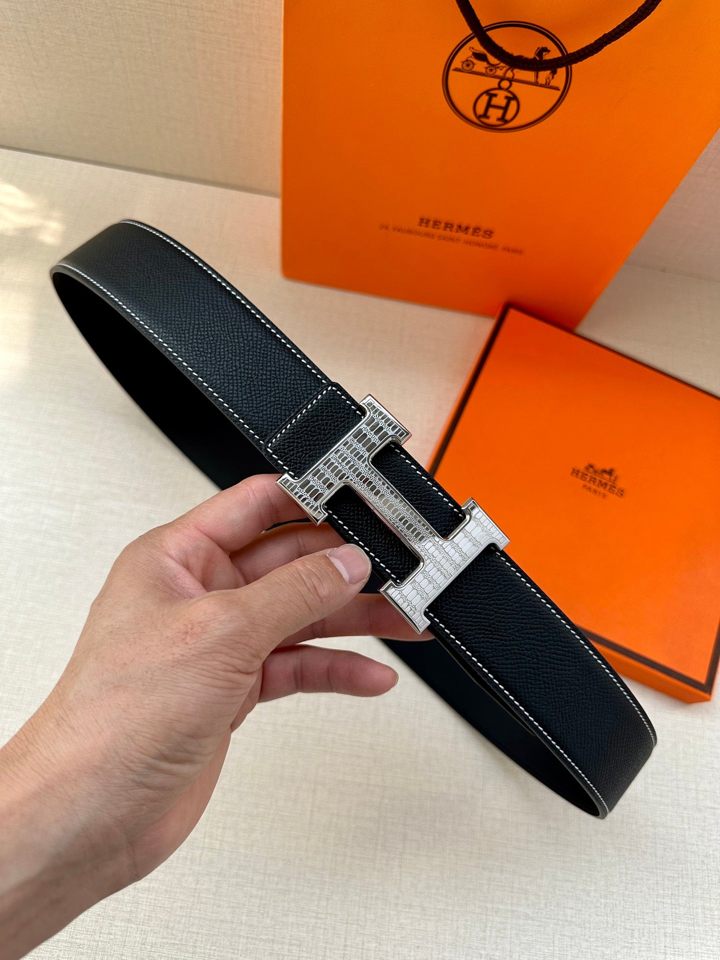 Hermes leather belt with H buckle in silver and gold, textured finish, white edge stitching