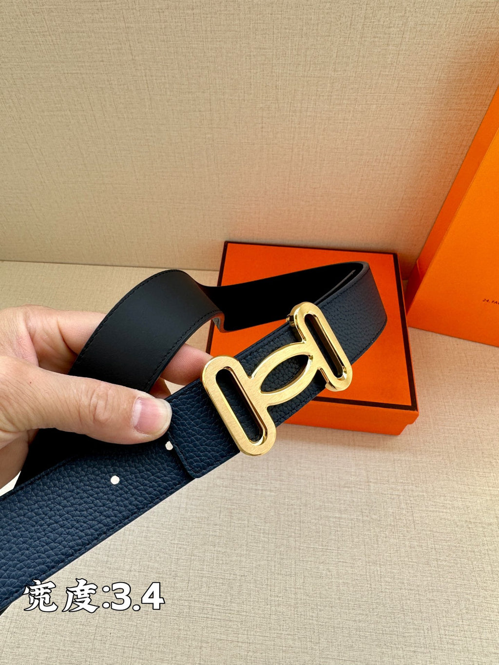 Navy leather belt with gold-tone double buckle, side view