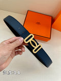 Navy leather belt with silver-tone double buckle, held by hand