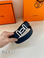 Navy leather belt with silver-tone double buckle, hand holding