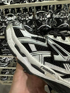 Black and white Balenciaga sneaker with honeycomb textured panels and lace-up front.