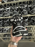 Black and white Balenciaga sneakers with rear branding and chunky tread sole.