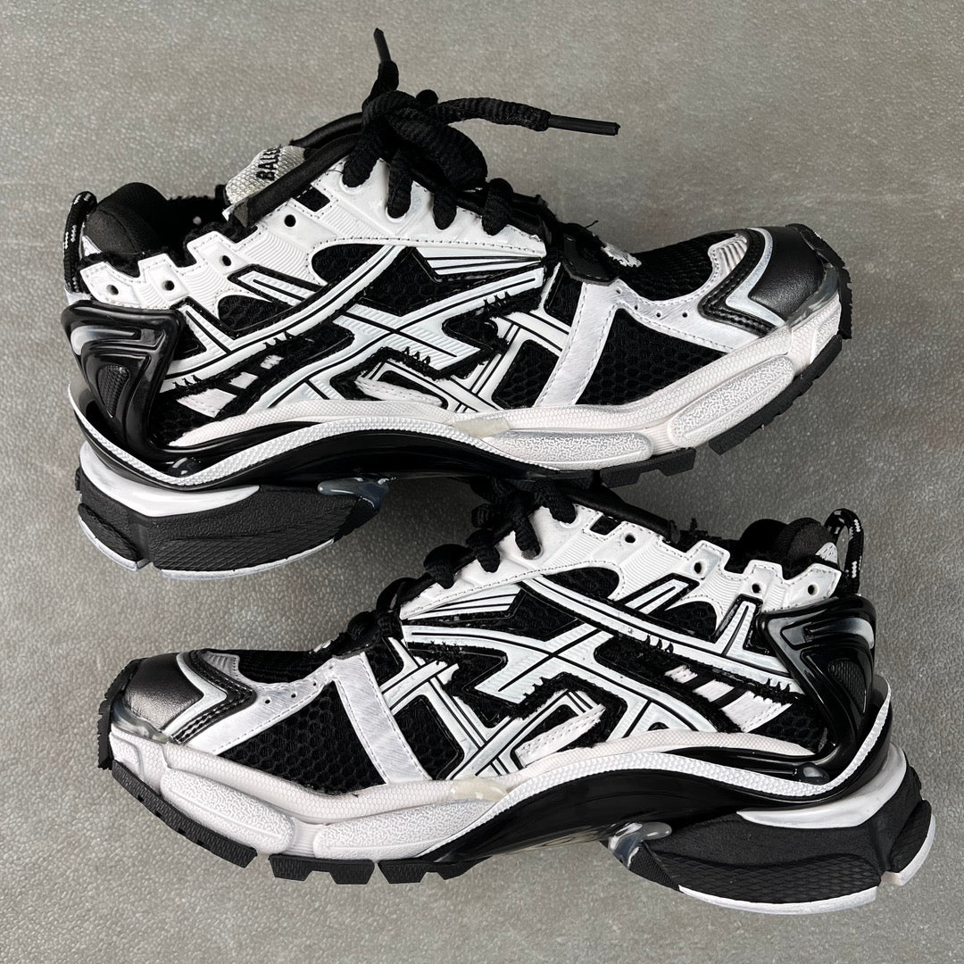 Balenciaga unisex sneakers, angled pair view, white and black, lace-up, chunky sole