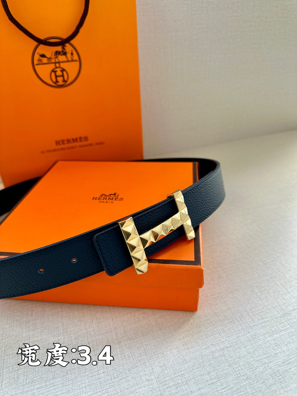 Hermes leather belt with dark blue strap and gold-toned studded square buckle