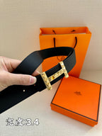 Black textured leather belt with silver-tone studded buckle, held curved