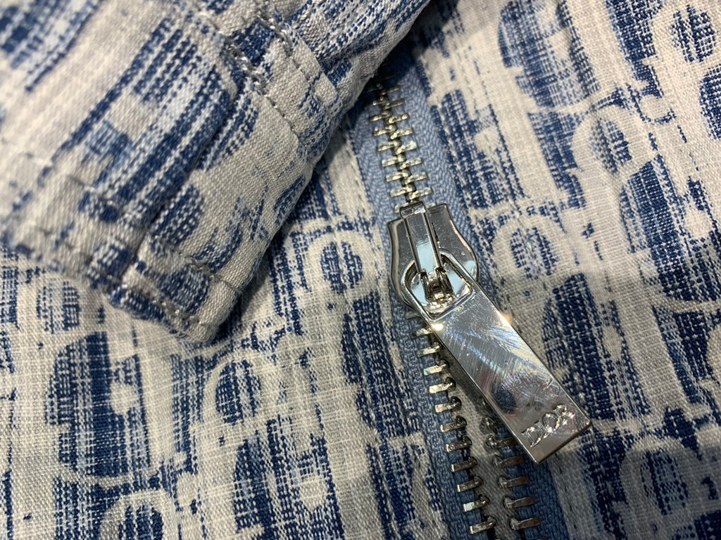 Blue and white patterned jacket close-up of silver zipper and metal pull tab