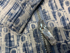 Blue and white patterned jacket close-up of silver zipper and metal pull tab