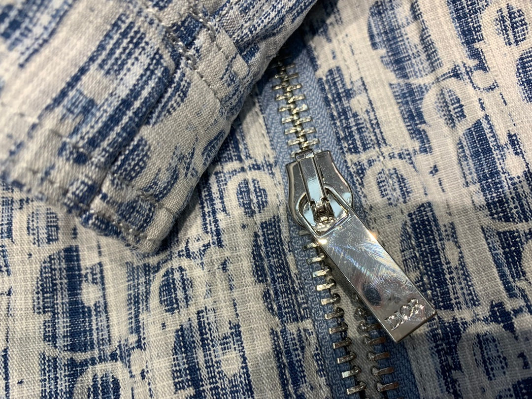 Blue and white patterned jacket close-up of silver zipper and metal pull tab