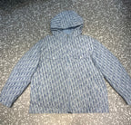 Close-up of blue and white patterned hooded long jacket with zip front and side pockets