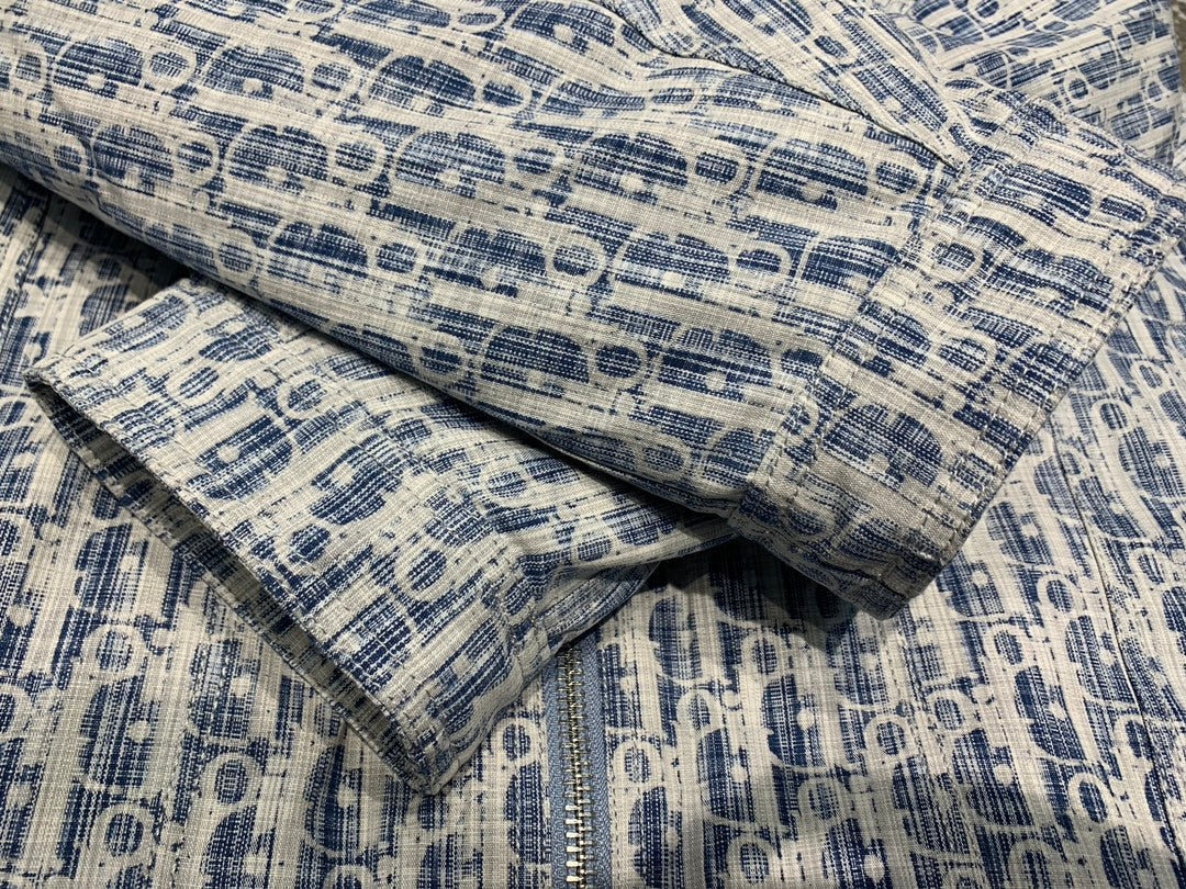 Blue and white patterned hooded jacket fabric detail with textured woven look