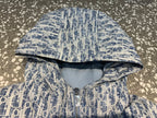 Hooded long jacket interior view with blue and white patterned outer and soft padding