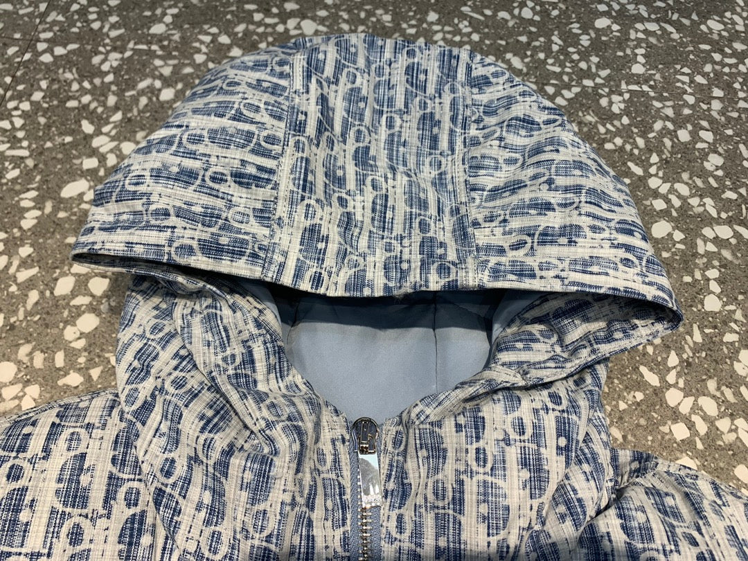 Hooded long jacket interior view with blue and white patterned outer and soft padding