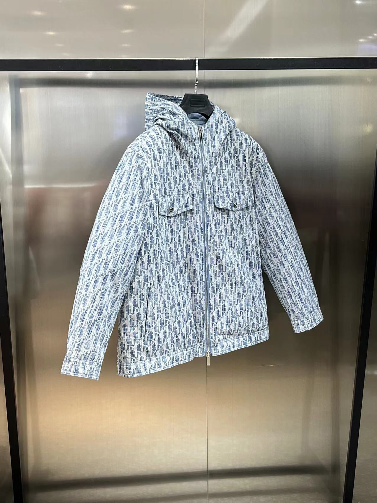 Blue and white patterned hooded long jacket on hanger, full-length sleeves, zip front