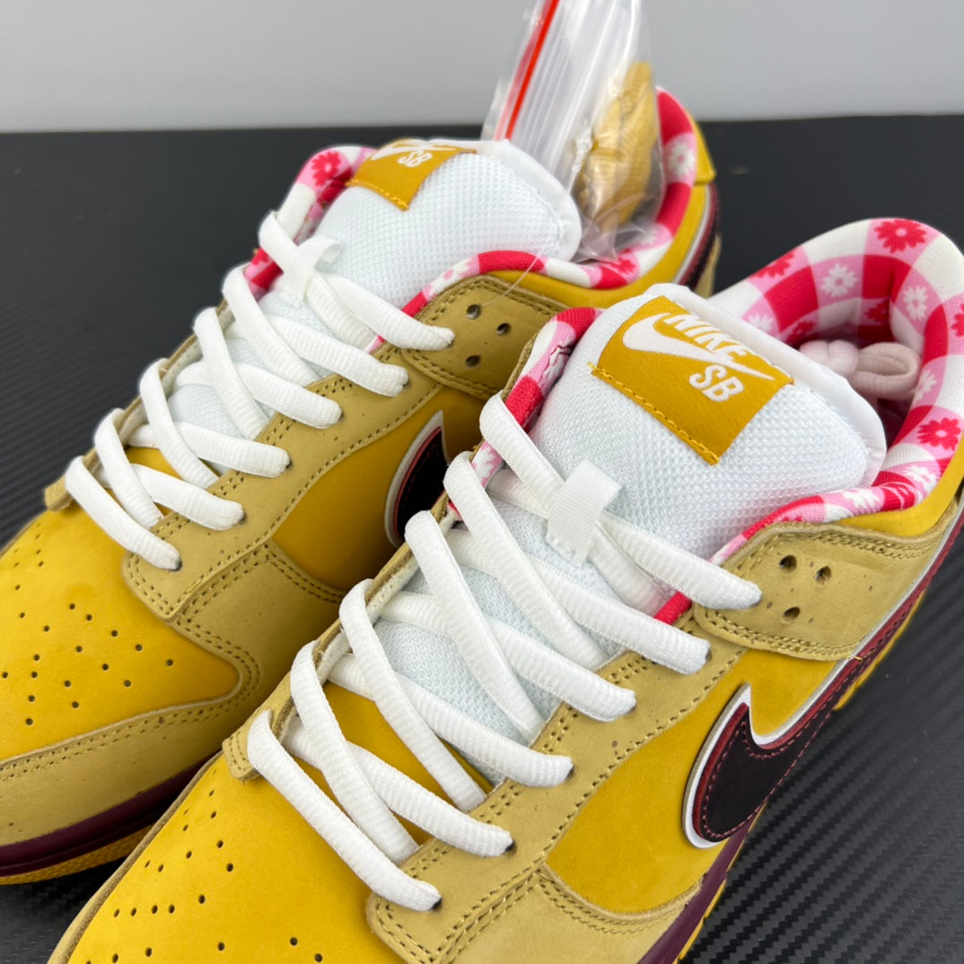 Yellow low-top sneakers with white laces, floral tongue lining, maroon swoosh.