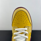 Yellow suede toe box with perforations and white lace eyelets, maroon border.