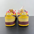 Yellow sneakers with white laces and Nike SB heel label, maroon outsole edge.