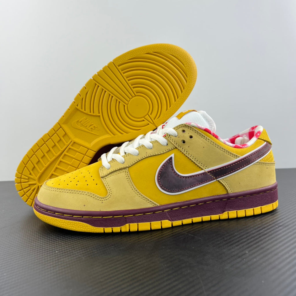 Yellow sneaker outsole with circular tread, white laces, and maroon trim.