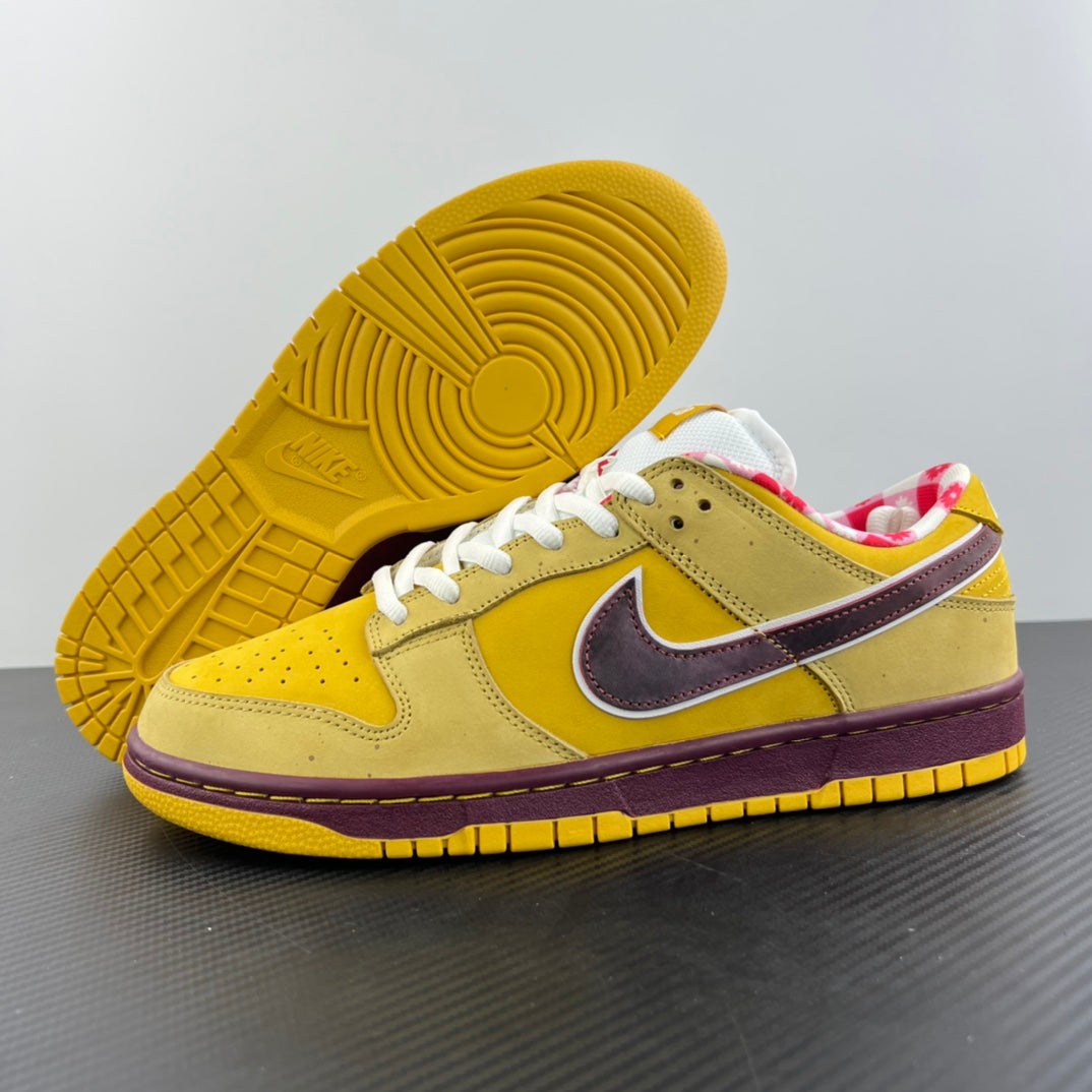 Yellow sneaker outsole with circular tread, white laces, and maroon trim.