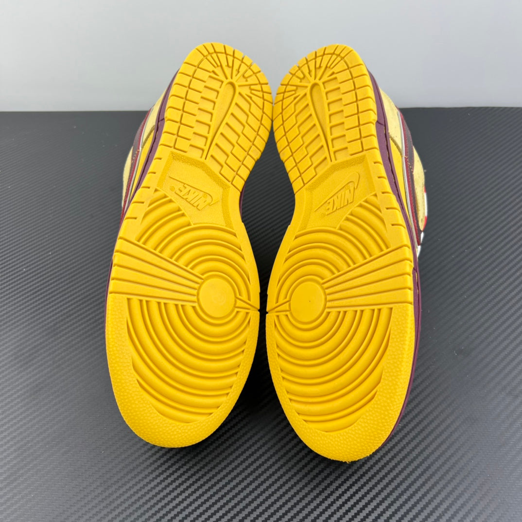 Yellow sneaker outsoles facing up with deep tread and grid details.