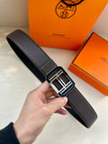 Dark leather belt with textured strap and silver square buckle with interlocking H motif