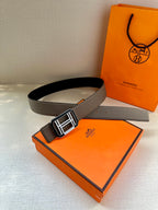 Gray leather belt with square silver buckle, shown laid and looped