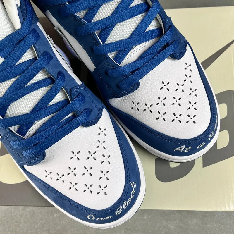 Blue-and-white low-top sneakers with perforated toe box and blue lace-up front
