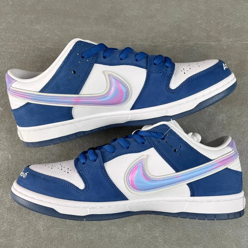 Blue-and-white low-top sneakers with iridescent swoosh accent and padded collar