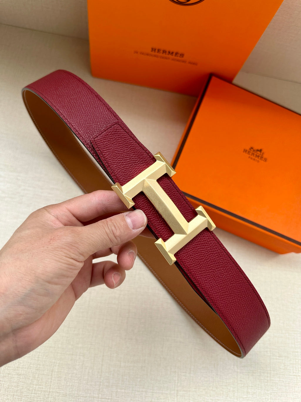 Hermes belt with burgundy leather strap and gold-tone buckle hardware