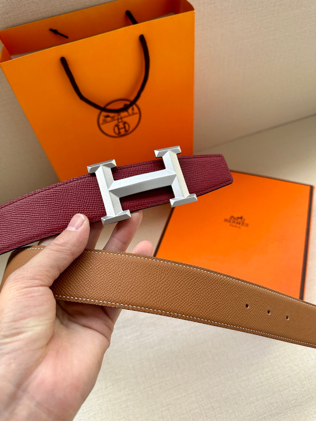 Hermes belt with burgundy leather strap and silver-tone buckle with open frame