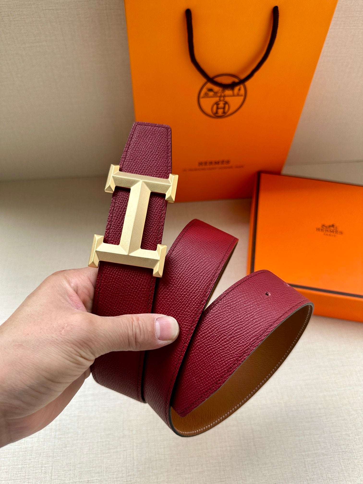 Hermes belt with burgundy leather strap and silver-tone buckle detail