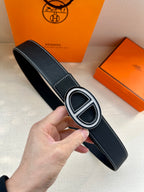 Dark blue leather belt with oval buckle, contrast stitching