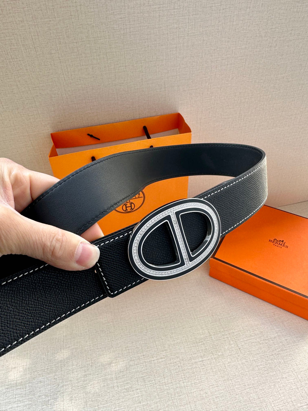 Dark leather belt with oval buckle and single keeper, belt loop side