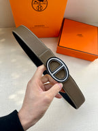 Taupe leather belt with silver-tone oval buckle and stitched edge
