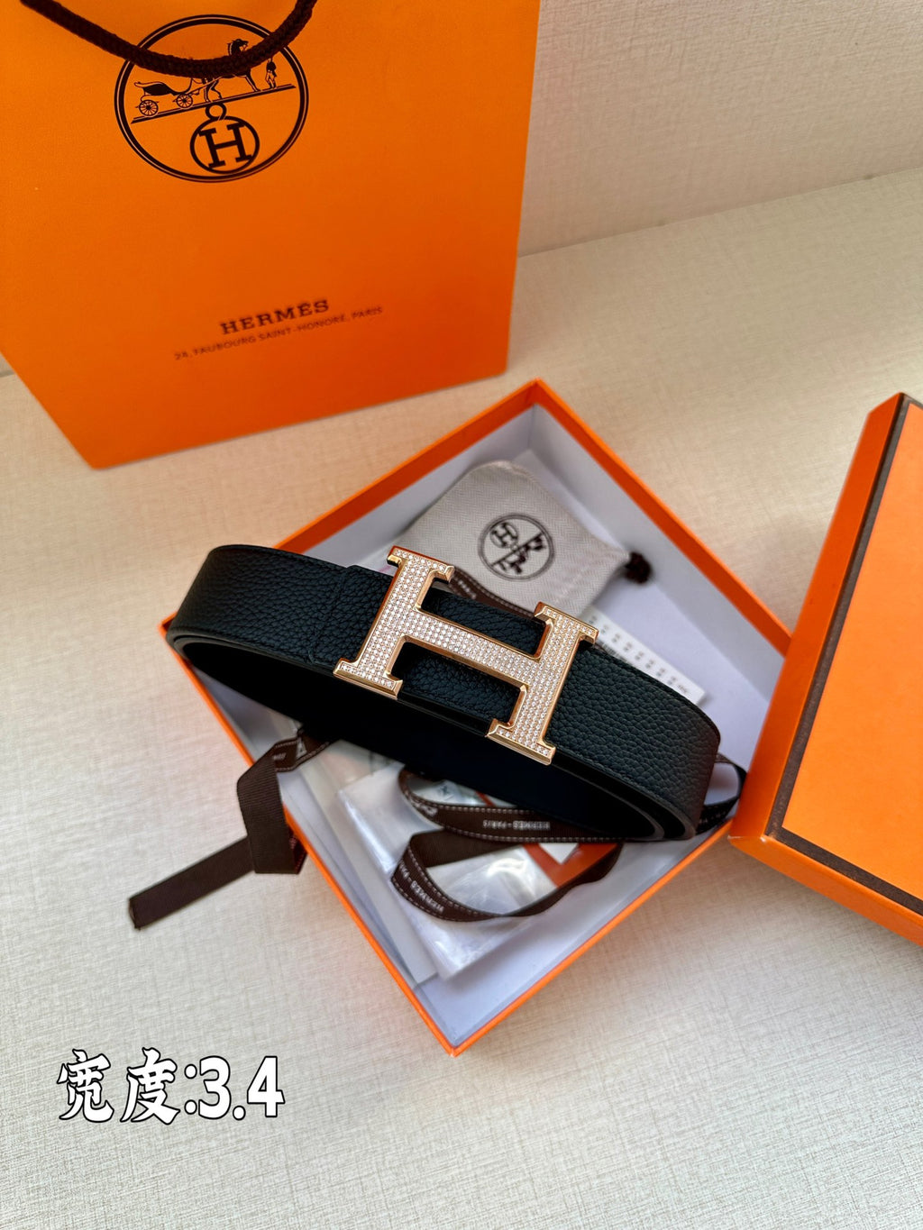Dark Hermes belt with textured leather and silver studded H buckle