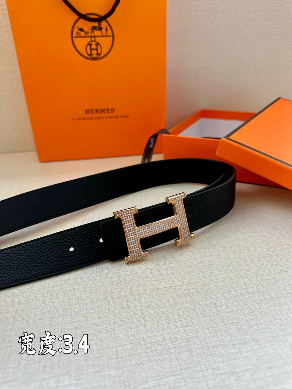 Dark Hermes belt with silver studded H buckle on the strap
