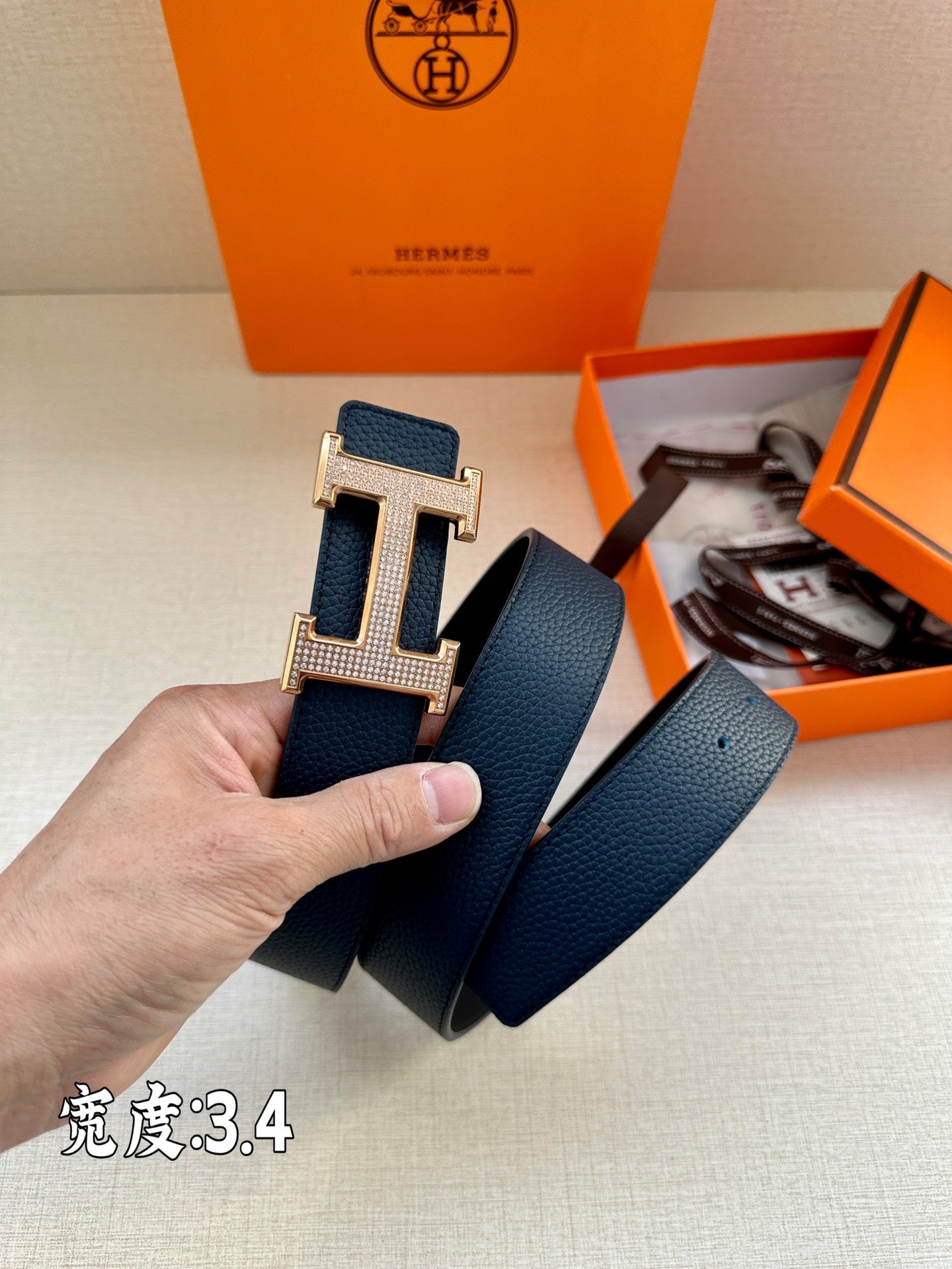 Leather belt, dark blue with silver-tone H buckle and folded strap