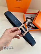 Leather belt, dark blue with silver-tone H buckle and punched holes