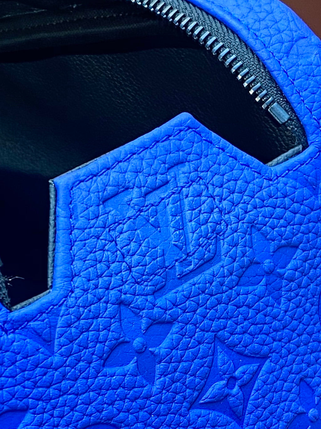 Blue embossed Louis Vuitton zip pouch bag interior lining and stitched opening