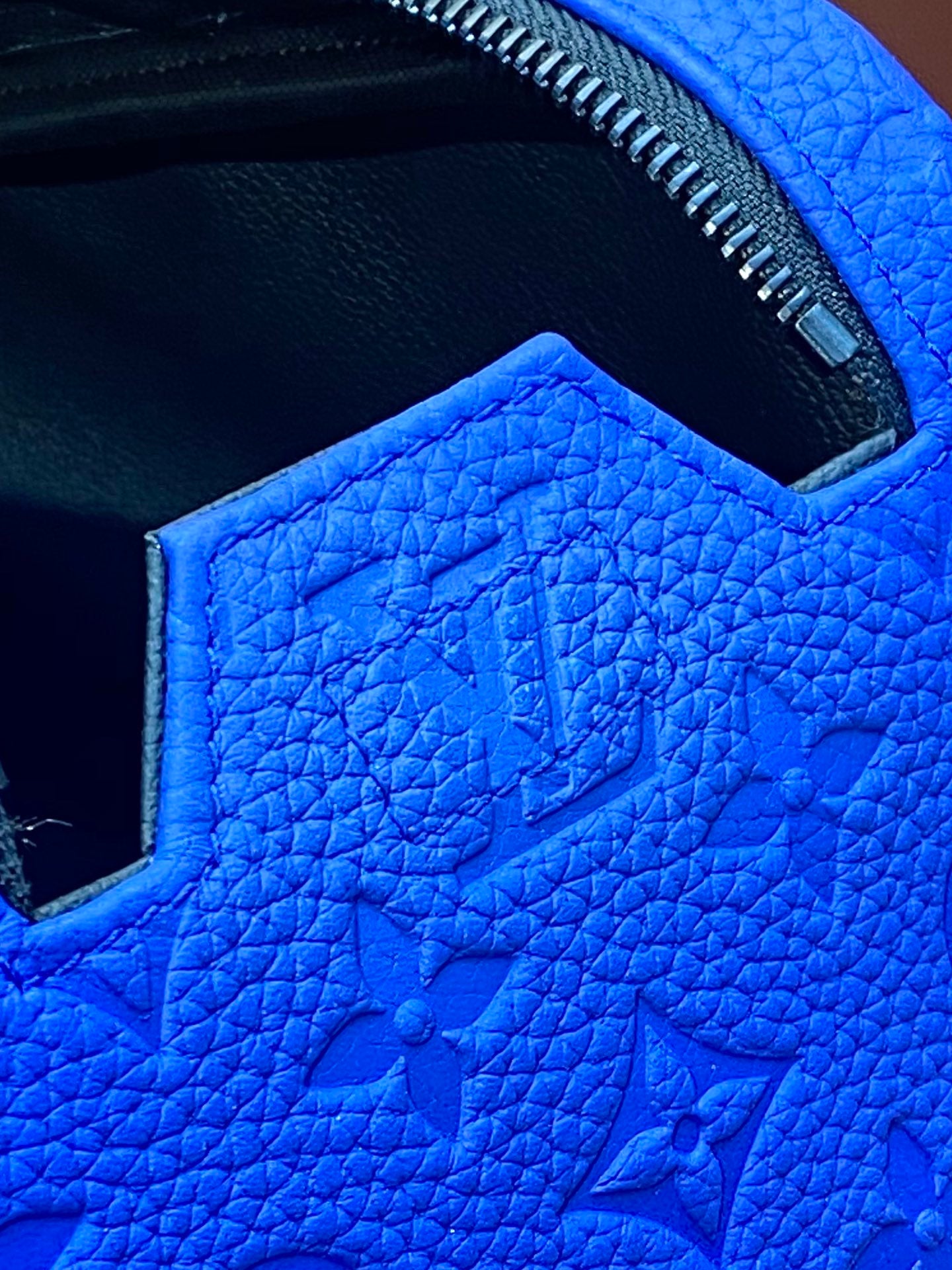 Blue embossed Louis Vuitton zip pouch bag interior lining and stitched opening