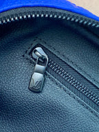 Blue Louis Vuitton zip pouch bag zipper pull on textured leather-look finish