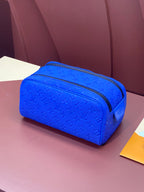 Blue embossed Louis Vuitton zip pouch bag with textured monogram pattern