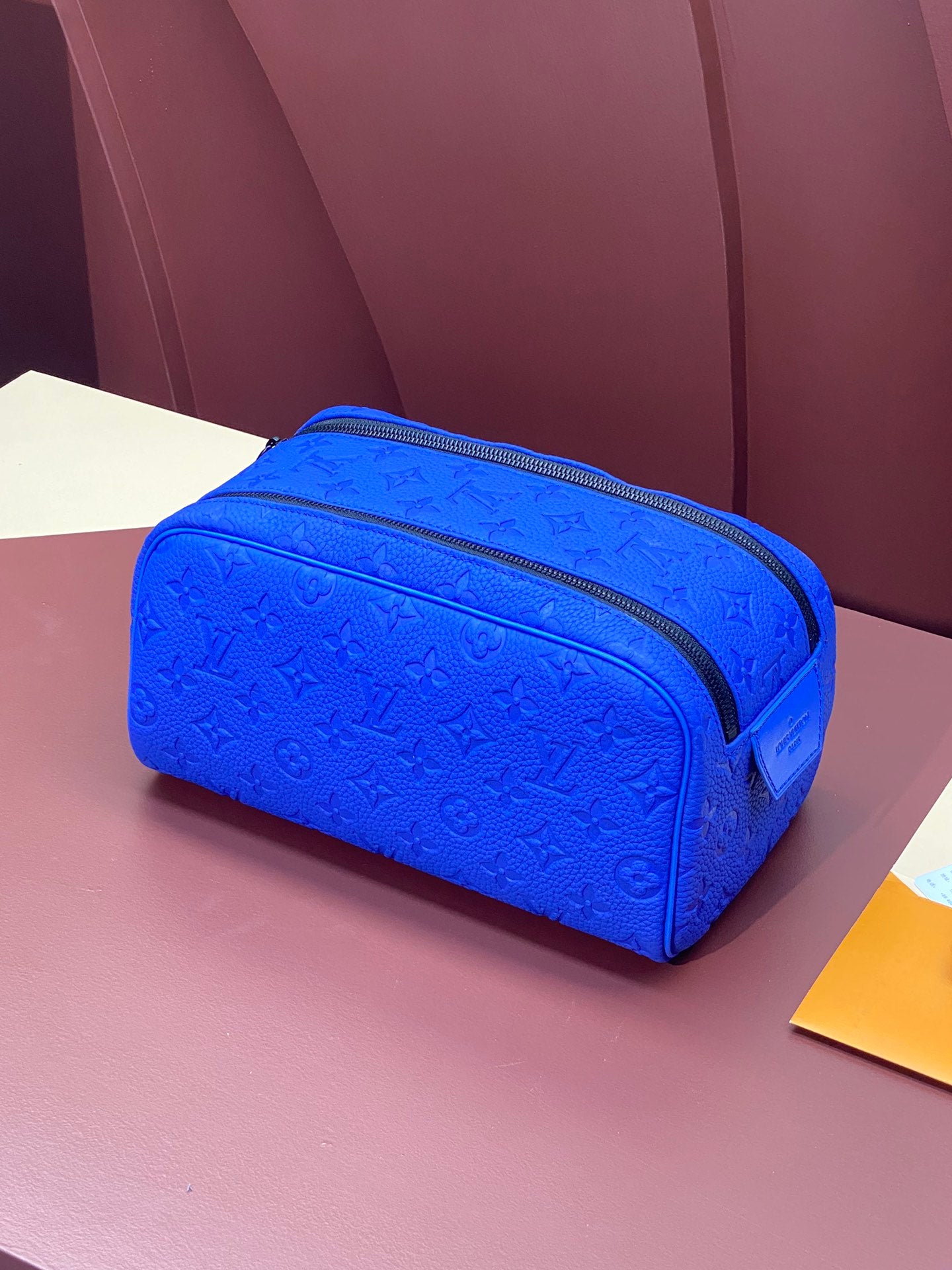 Blue embossed Louis Vuitton zip pouch bag with textured monogram pattern
