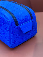 Blue embossed Louis Vuitton zip pouch bag with front patch logo and black zipper edge