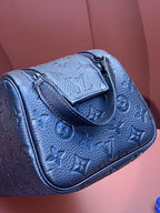 Louis Vuitton blue monogram leather belt bag side view with top loop handle and zipper trim